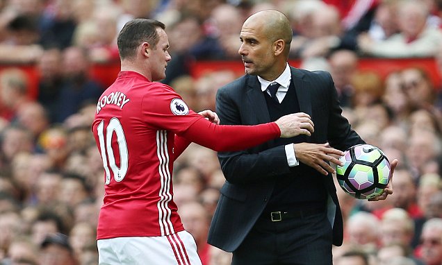 Wayne Rooney of Manchester United tries to take the ball from Manchester City manager Pep Guardiola during the Premier League match between Manchester United and Manchester City played at Old Trafford, Manchester on 10th September 2016